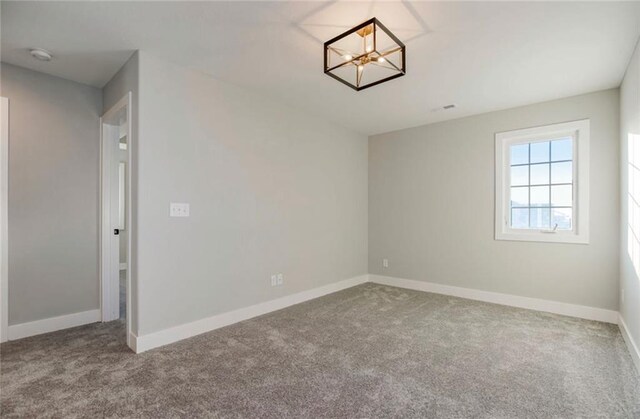 3217 SW Saddlebred Ter, Lees Summit, MO 64082 - spare room with carpet, baseboards, a chandelier, and a smoke detector
