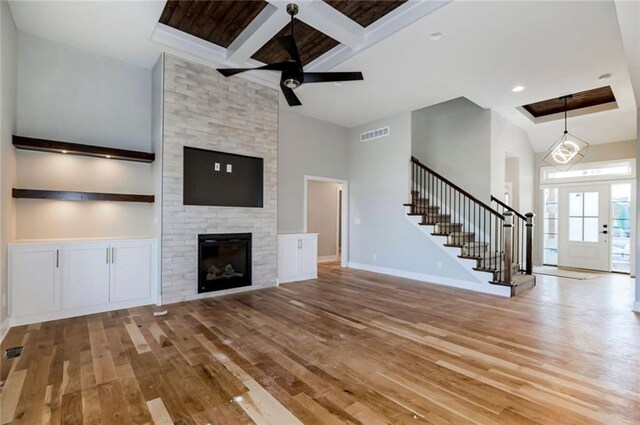 3217 SW Saddlebred Ter, Lees Summit, MO 64082 - unfurnished living room with wood-type flooring, stairs, a ceiling fan, baseboards, and beam ceiling
