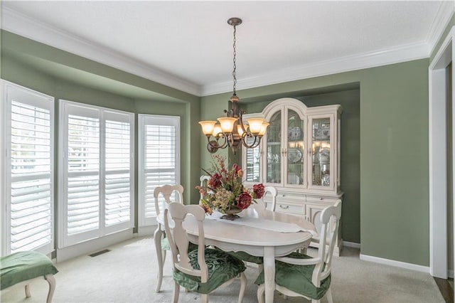 dining area featuring crown molding, visible vents, light colored carpet, and an inviting chandelier