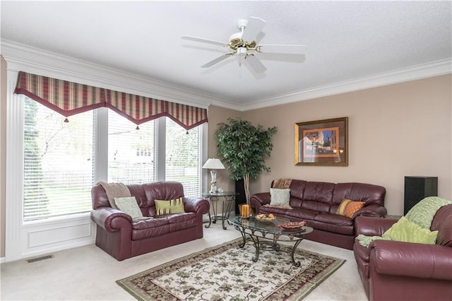 carpeted living room featuring ornamental molding, visible vents, and plenty of natural light