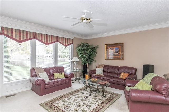living room featuring crown molding, carpet flooring, visible vents, and plenty of natural light