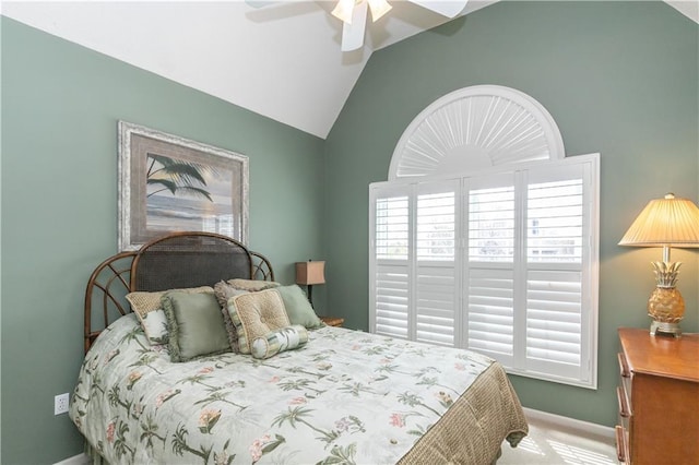 bedroom with ceiling fan, baseboards, and vaulted ceiling