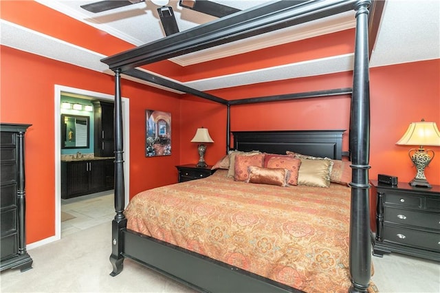 bedroom featuring light carpet and ensuite bath
