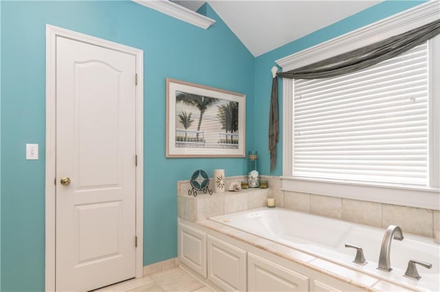 full bath with tile patterned floors, a garden tub, and vaulted ceiling