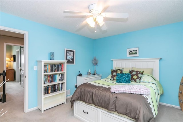 bedroom featuring baseboards, a ceiling fan, and light colored carpet