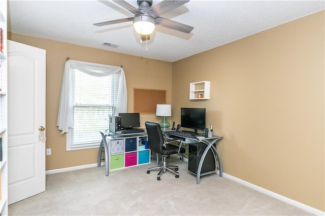 carpeted home office featuring ceiling fan, baseboards, and visible vents