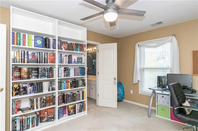 office area with carpet flooring, baseboards, a ceiling fan, and visible vents