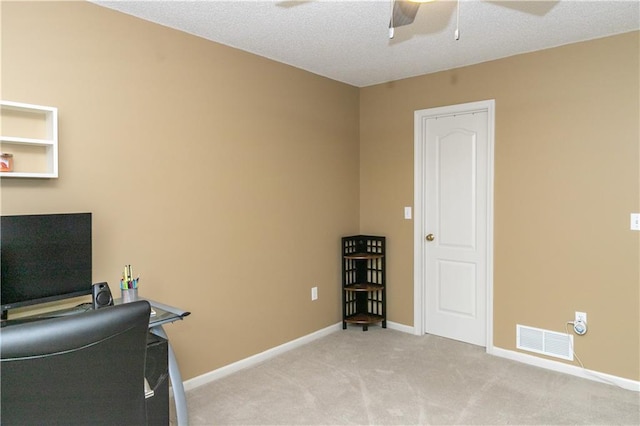 office featuring light carpet, baseboards, a ceiling fan, and visible vents