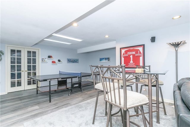 interior space with recessed lighting, french doors, baseboards, and wood finished floors