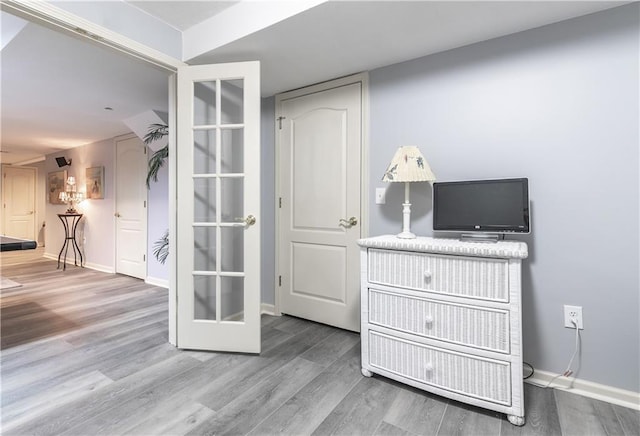 interior space featuring baseboards and wood finished floors