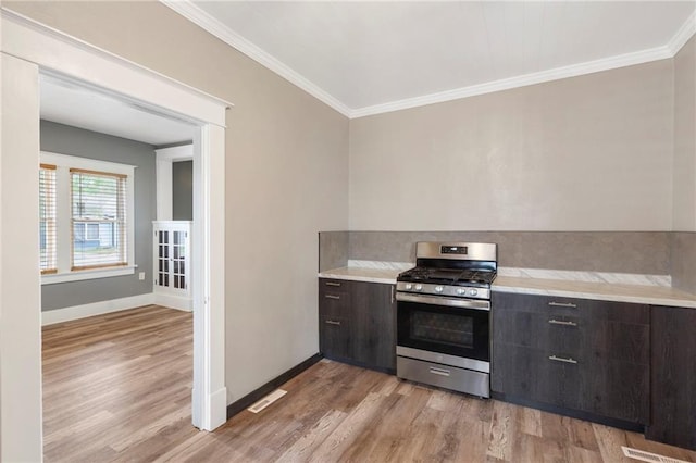 kitchen featuring light countertops, light wood-style flooring, and gas stove