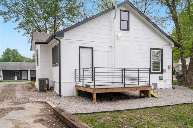 back of property with central air condition unit and a wooden deck