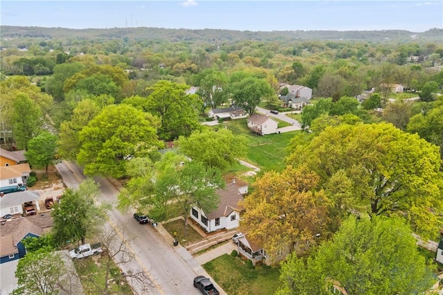 birds eye view of property featuring a wooded view and a residential view