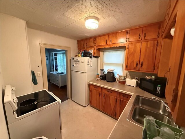 110 W Mechanic Ave, Independence, MO 64050 - kitchen with white appliances, brown cabinetry, and a sink