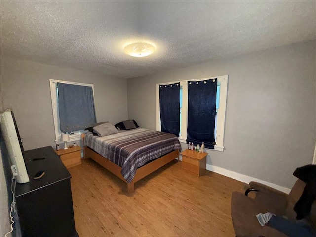 110 W Mechanic Ave, Independence, MO 64050 - bedroom featuring light wood-style floors, a textured ceiling, and baseboards