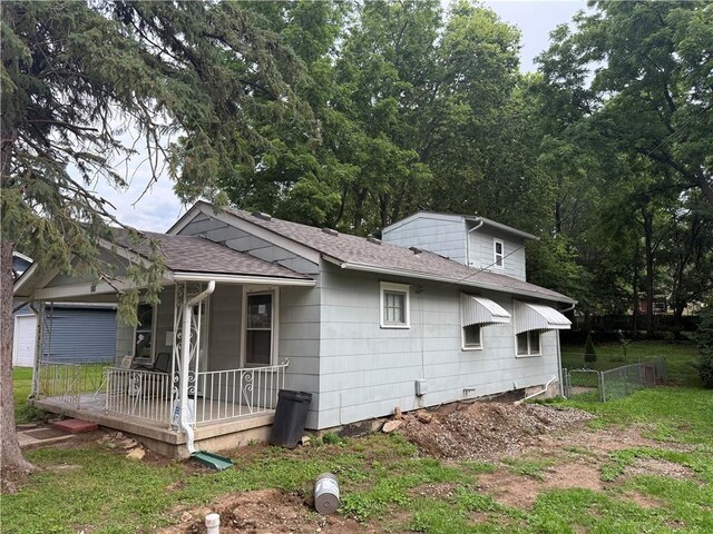110 W Mechanic Ave, Independence, MO 64050 - view of property exterior with a porch and roof with shingles