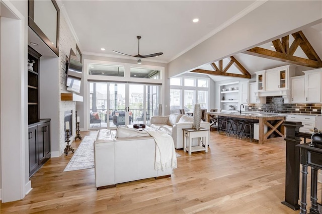 7530 N Gower Ave, Kansas City, MO 64151 - living area with light wood-style floors, ceiling fan, a fireplace, ornamental molding, and recessed lighting