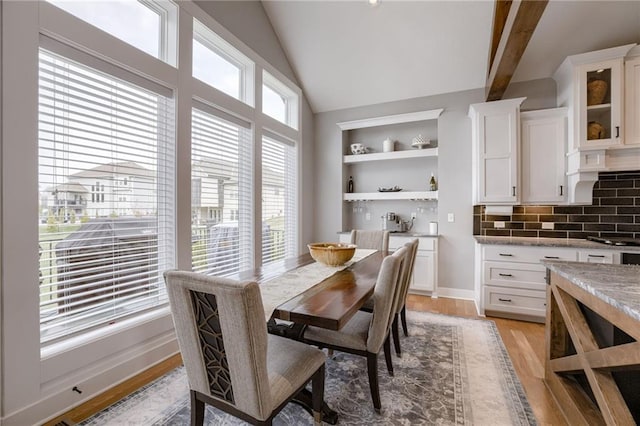 7530 N Gower Ave, Kansas City, MO 64151 - dining space with light wood-style floors, built in features, and lofted ceiling