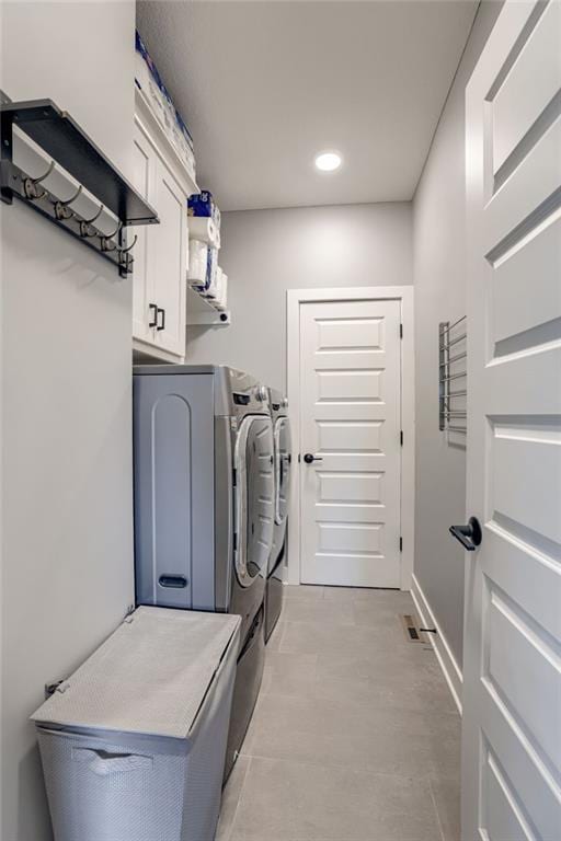 7530 N Gower Ave, Kansas City, MO 64151 - clothes washing area featuring baseboards, cabinet space, washing machine and dryer, and recessed lighting