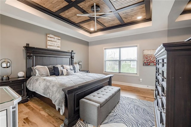 7530 N Gower Ave, Kansas City, MO 64151 - bedroom featuring light wood-type flooring, a tray ceiling, crown molding, and wood ceiling
