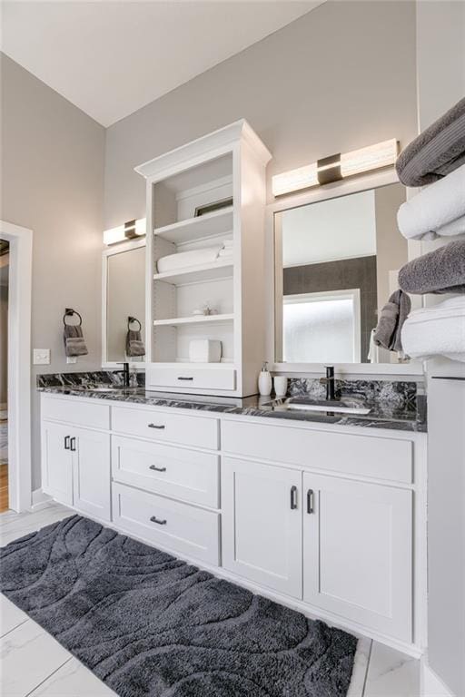 7530 N Gower Ave, Kansas City, MO 64151 - bathroom featuring a sink, double vanity, and marble finish floor