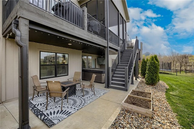 7530 N Gower Ave, Kansas City, MO 64151 - view of patio / terrace featuring a vegetable garden, fence, a hot tub, and stairs