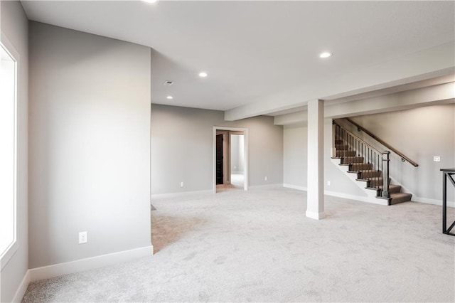 below grade area with recessed lighting, stairs, light colored carpet, and baseboards