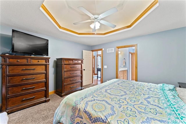 8110 NE 72nd Ter, Kansas City, MO 64158 - bedroom with ceiling fan, ensuite bathroom, a tray ceiling, visible vents, and light carpet
