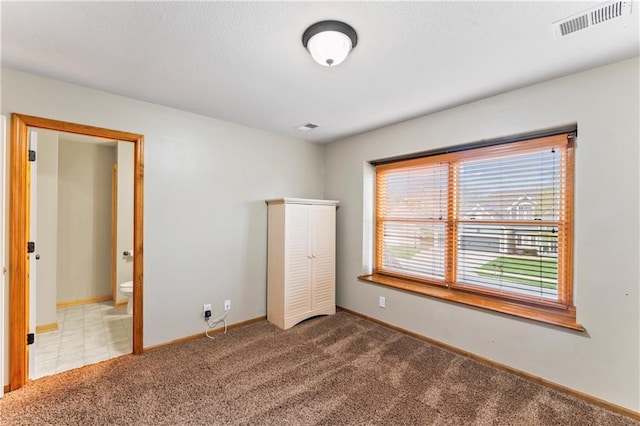 8110 NE 72nd Ter, Kansas City, MO 64158 - unfurnished bedroom featuring carpet flooring, baseboards, and visible vents