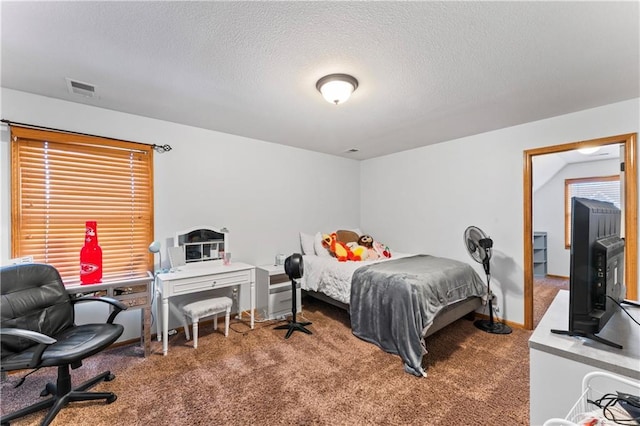 8110 NE 72nd Ter, Kansas City, MO 64158 - bedroom featuring carpet floors, visible vents, and a textured ceiling