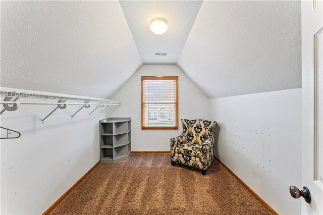 8110 NE 72nd Ter, Kansas City, MO 64158 - sitting room with baseboards, vaulted ceiling, a textured ceiling, visible vents, and carpet
