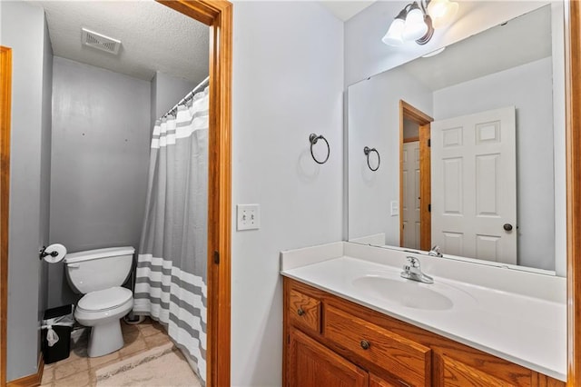 8110 NE 72nd Ter, Kansas City, MO 64158 - full bathroom featuring visible vents, toilet, a textured ceiling, vanity, and tile patterned floors