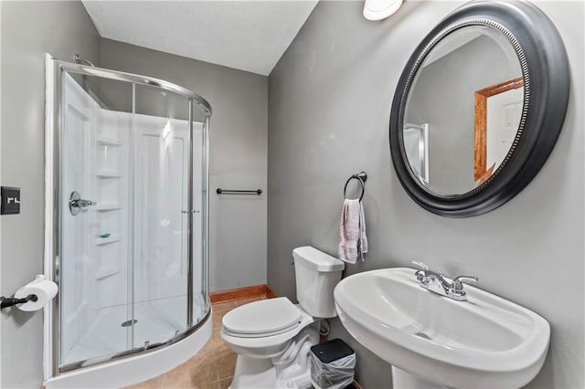 8110 NE 72nd Ter, Kansas City, MO 64158 - bathroom featuring a sink, tile patterned floors, toilet, and a stall shower