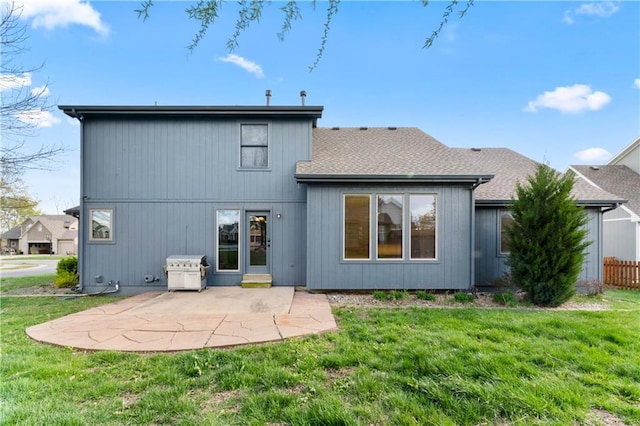 8110 NE 72nd Ter, Kansas City, MO 64158 - back of property featuring roof with shingles, a patio area, and a lawn