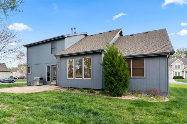 8110 NE 72nd Ter, Kansas City, MO 64158 - rear view of property featuring a patio, a yard, and roof with shingles