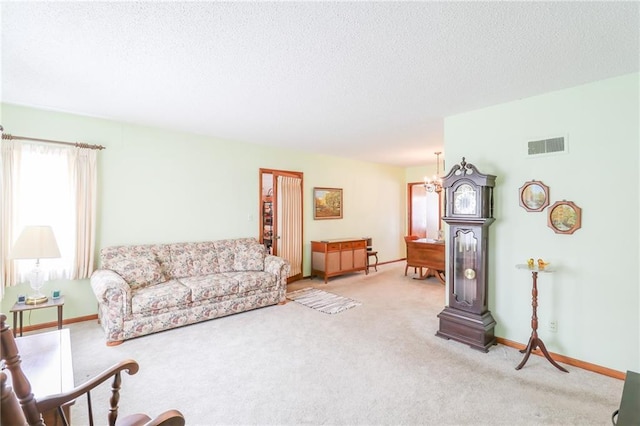 1601 S Market St, Holden, MO 64040 - living area featuring a textured ceiling, carpet flooring, baseboards, and visible vents