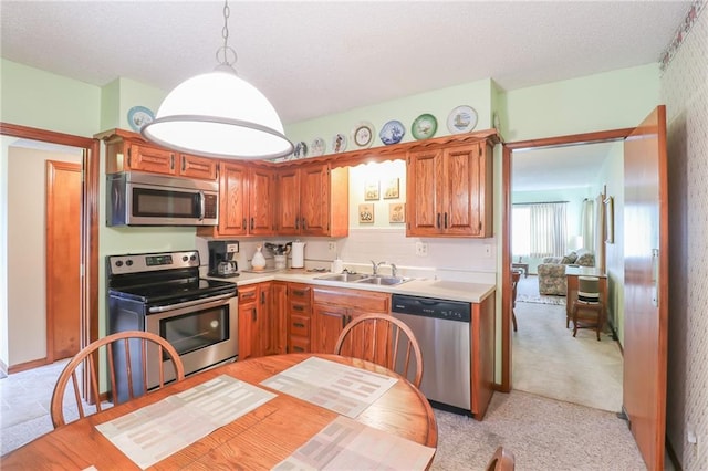 1601 S Market St, Holden, MO 64040 - kitchen with light countertops, a textured ceiling, a sink, and stainless steel appliances