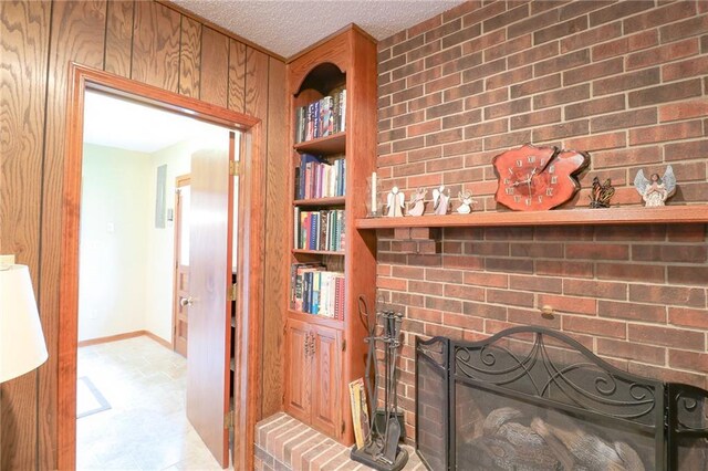 1601 S Market St, Holden, MO 64040 - details featuring baseboards, a fireplace, and a textured ceiling