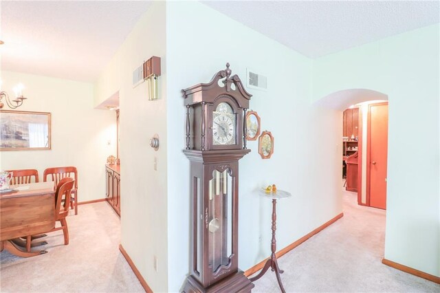 1601 S Market St, Holden, MO 64040 - hall featuring arched walkways, baseboards, light carpet, and visible vents
