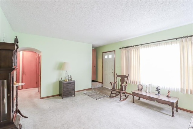 1601 S Market St, Holden, MO 64040 - living area with arched walkways, carpet, and a textured ceiling