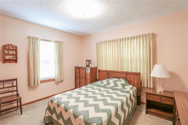1601 S Market St, Holden, MO 64040 - carpeted bedroom featuring baseboards and a textured ceiling