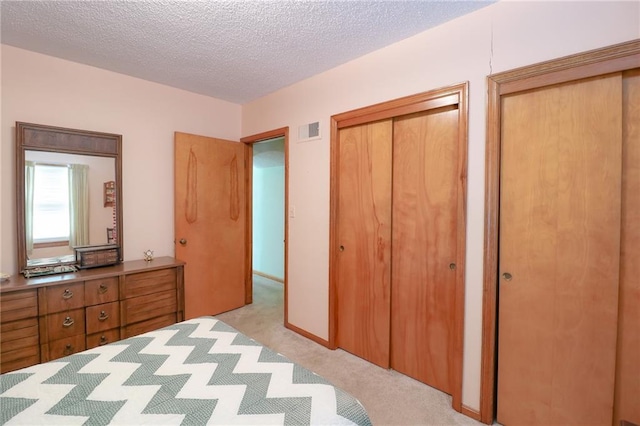 1601 S Market St, Holden, MO 64040 - unfurnished bedroom featuring visible vents, light colored carpet, and a textured ceiling