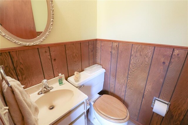1601 S Market St, Holden, MO 64040 - half bath with wood walls, toilet, and wainscoting