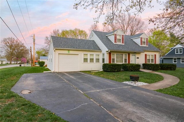 1601 S Market St, Holden, MO 64040 - new england style home featuring an attached garage, roof with shingles, a yard, and driveway
