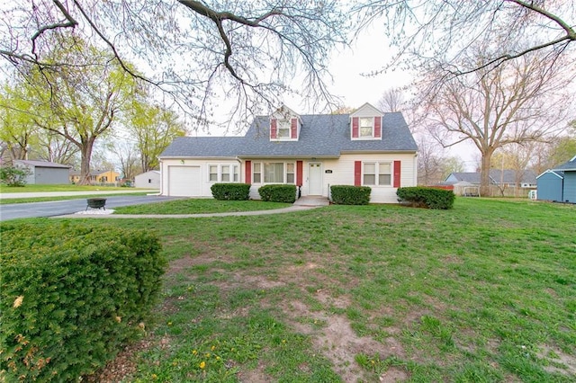 1601 S Market St, Holden, MO 64040 - cape cod-style house featuring an attached garage, a front lawn, and aphalt driveway