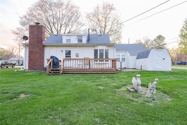 1601 S Market St, Holden, MO 64040 - back of house featuring an outdoor structure, a lawn, a chimney, a shingled roof, and a deck