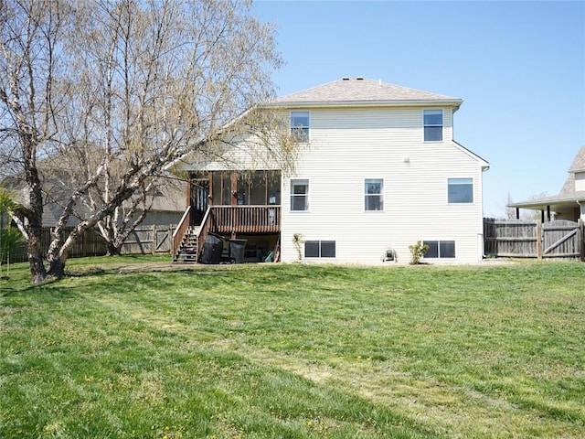 rear view of property with a yard, a sunroom, a fenced backyard, and stairway