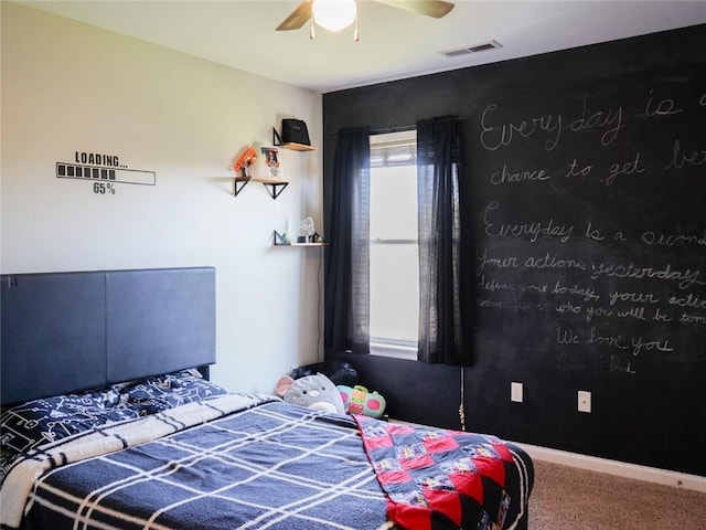 carpeted bedroom with visible vents and a ceiling fan