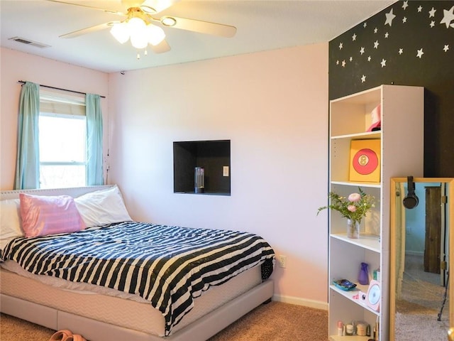 bedroom with carpet floors, a ceiling fan, visible vents, and baseboards
