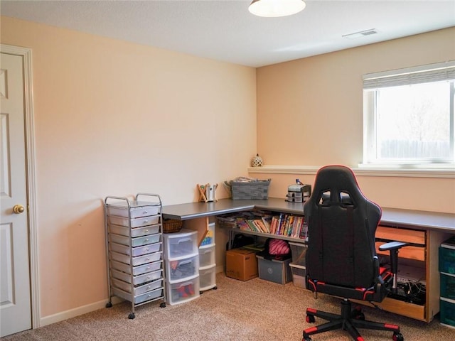 carpeted office space with visible vents and baseboards